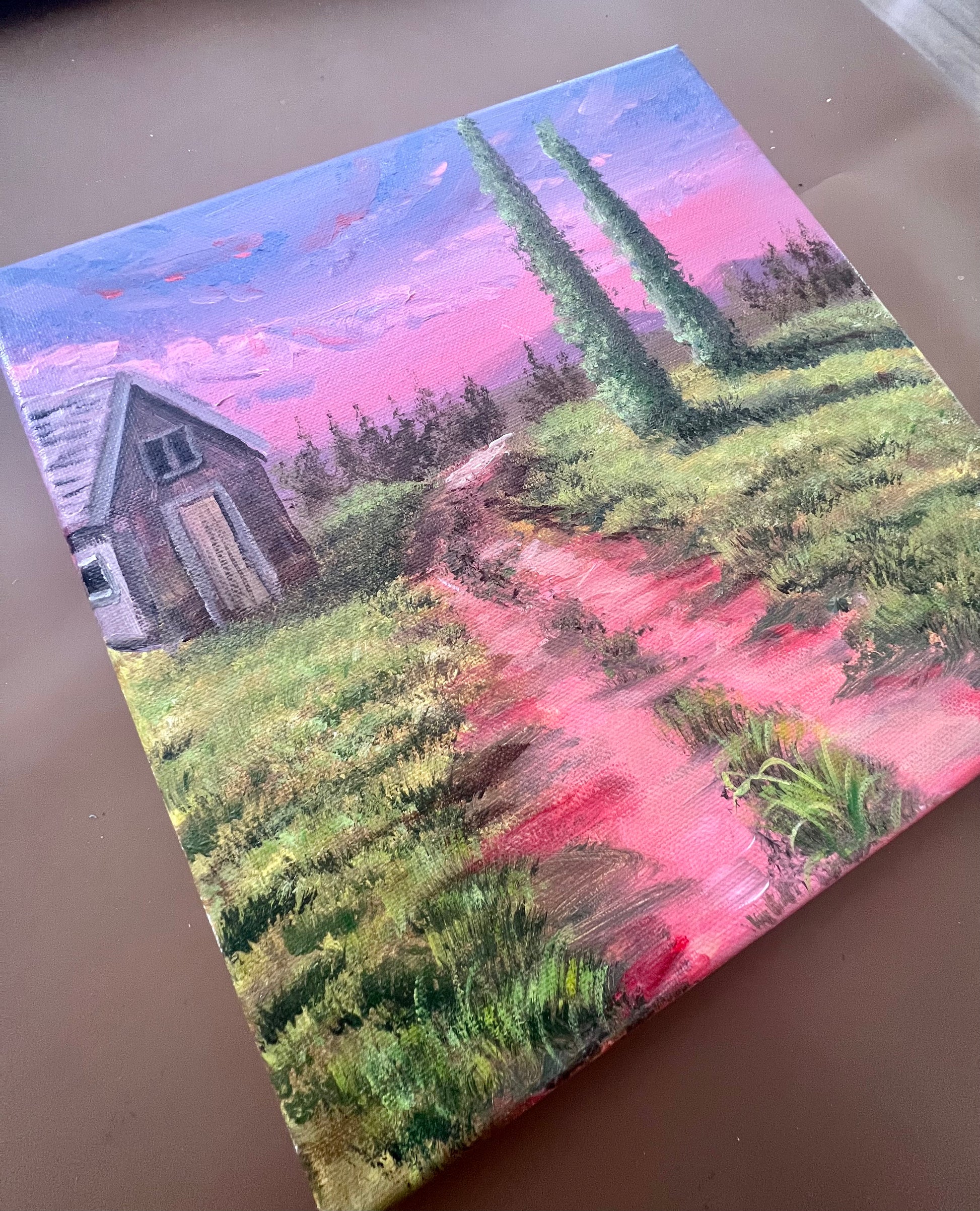 topiary trees and a cabin in a pink sunset art